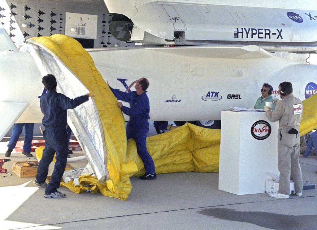 Technicians Remove Protective Shrouds from Pegasus