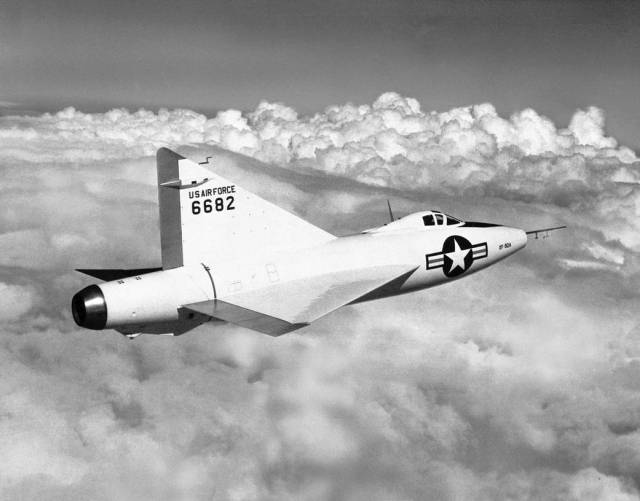This NACA High-Speed Flight Research Station photograph shows an aft view of the XF-92A in flight above a layer of clouds.