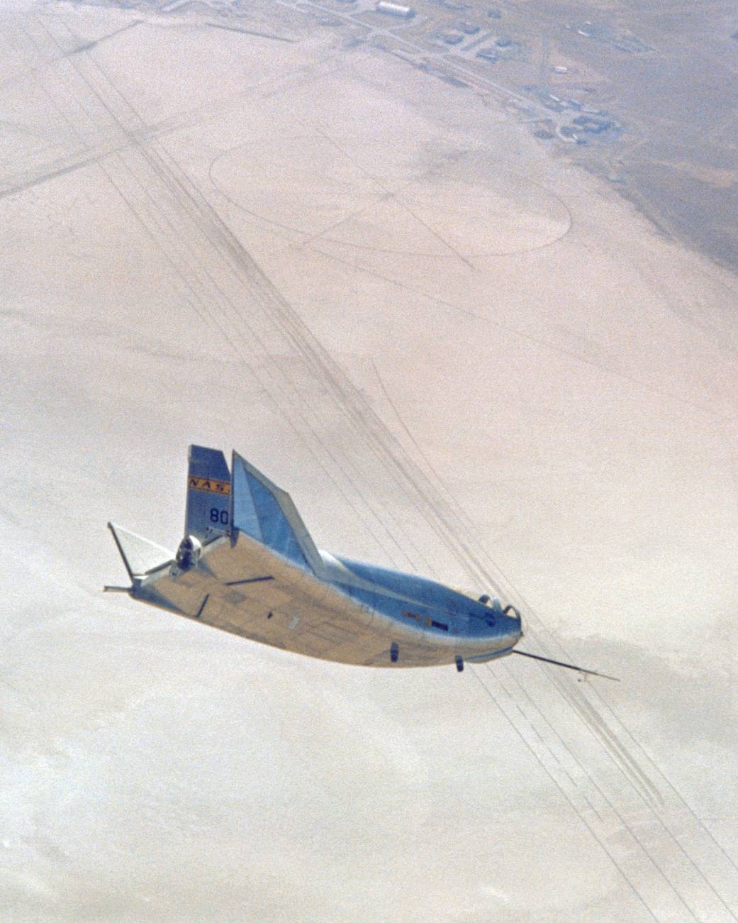 The HL-10 in flight, turning to line up with lakebed runway 18.