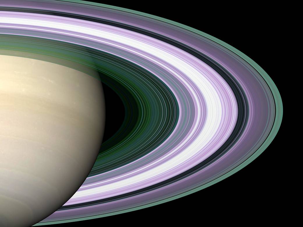 Closeup of right half of Saturn with rings in gold and violet colors