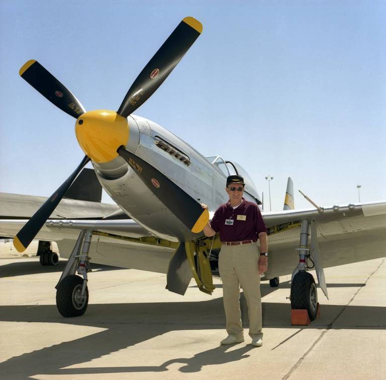 Man posed in front of aircraft.