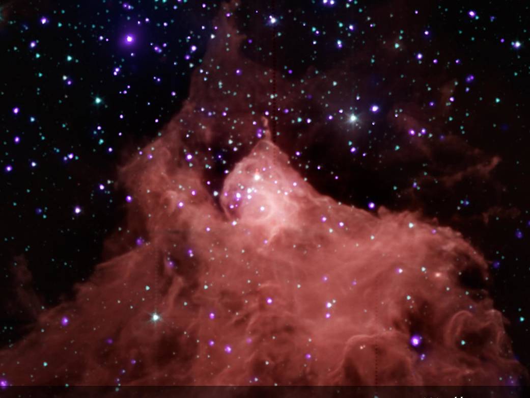 Reddish cloud of gas rising from bottom against deep space with stars visible throughout