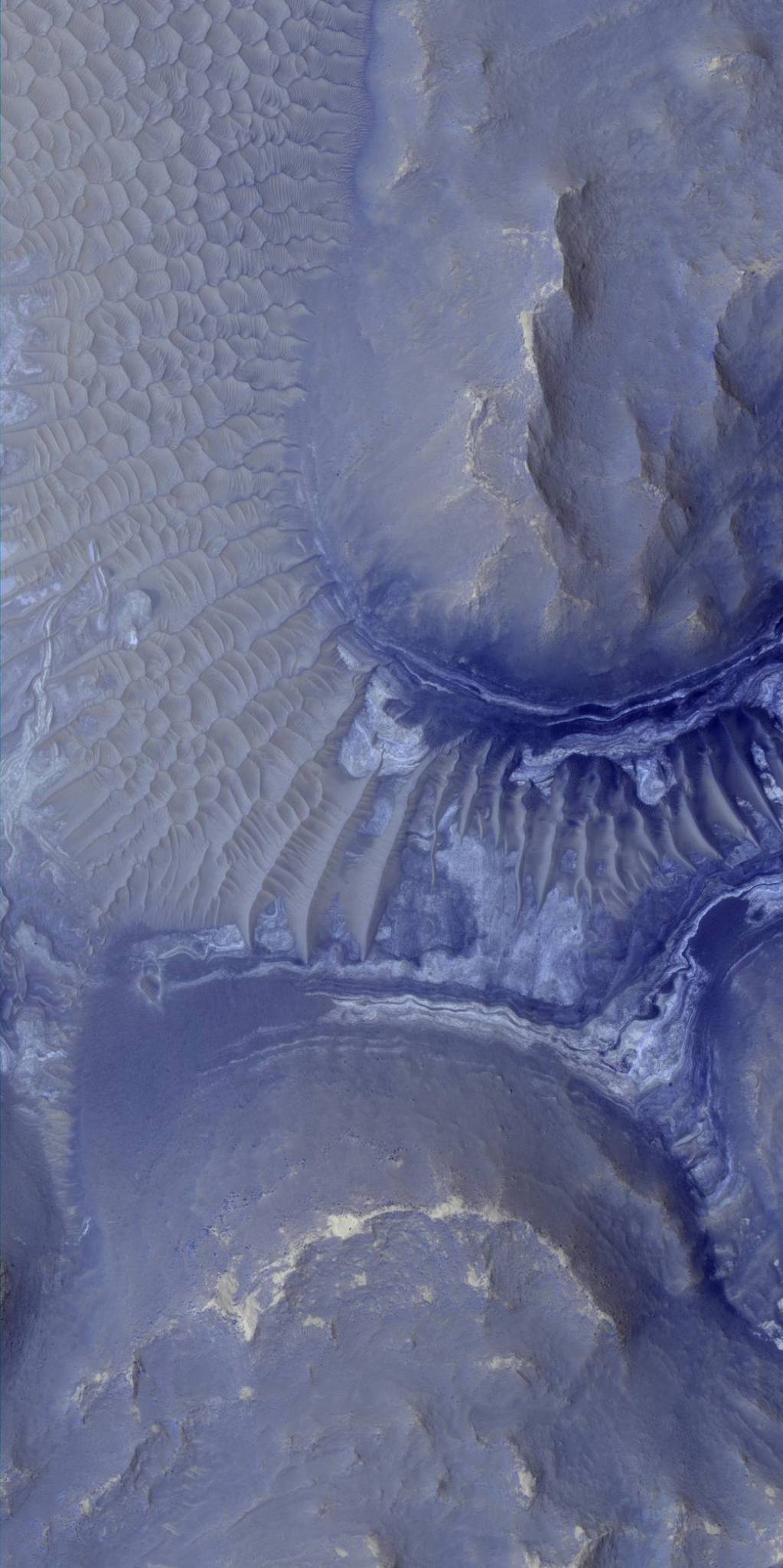 Layers and ridges in rocky terrain in pale blue false color