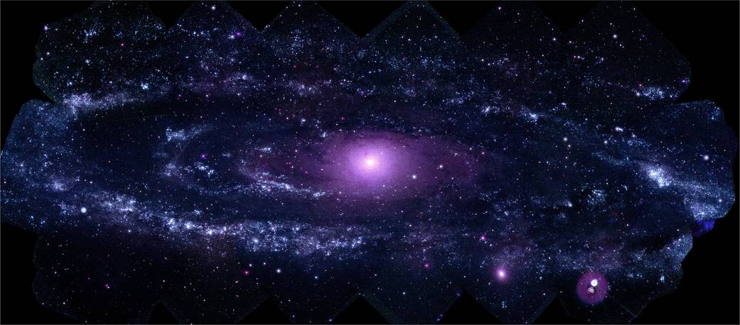 Wide spiral galaxy in false color ultraviolet - shades of violet and white in deep space