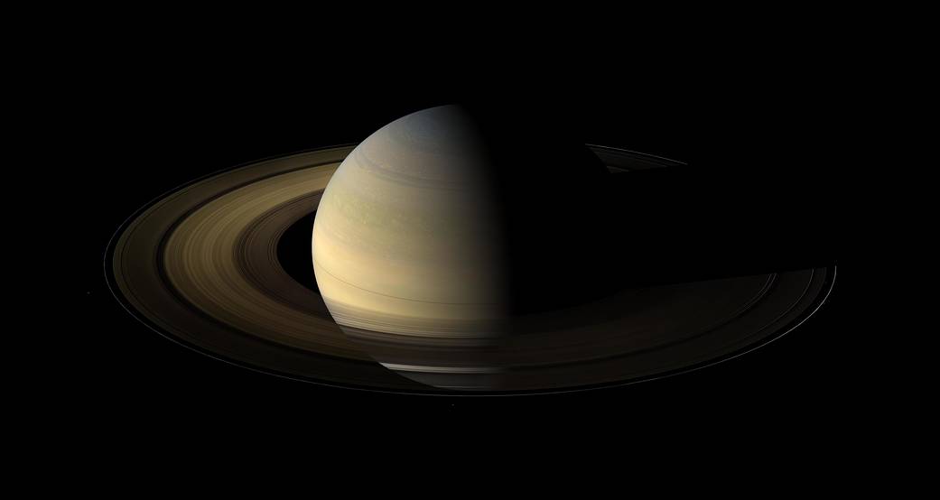 Saturn and rings half illuminated and half in darkness