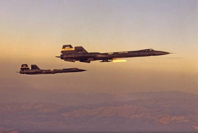 YF-12A and YF-12C in Flight Formation at Dawn