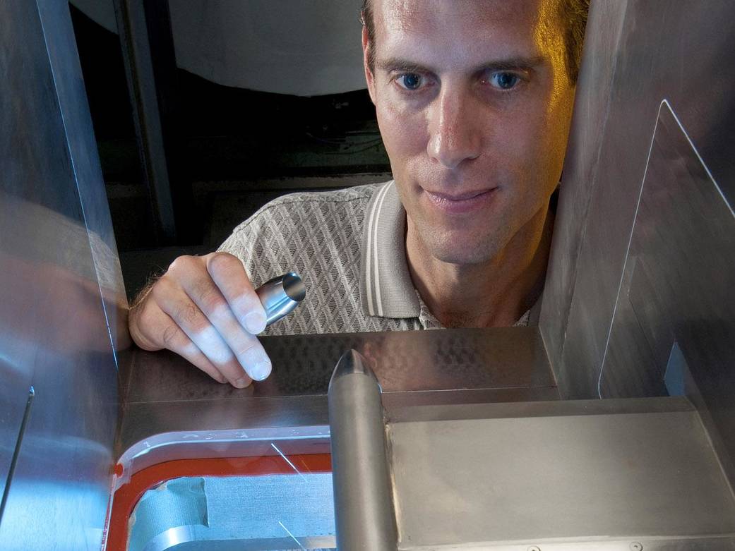 An engineer testing nozzle concepts in the 1-by 1-Foot Supersonic Wind Tunnel.