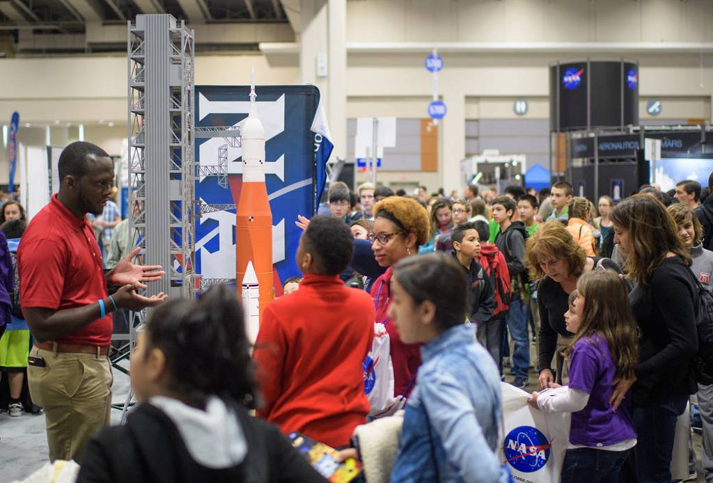 Attendees visit NASA exhibits during Sneak Peek Friday at the USA Science and Engineering Festival