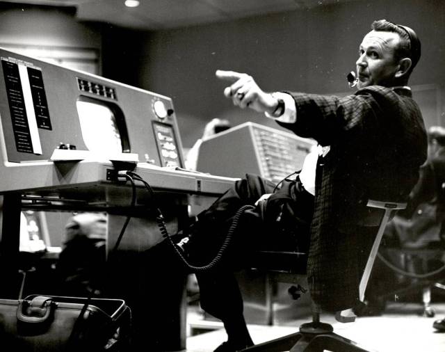 Christopher Kraft, flight director during Project Mercury, works at his console inside the Flight Control area at Mercury Mission Control.