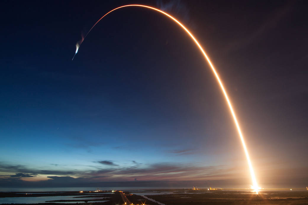 Arc of light across the early morning sky as rocket launches to space