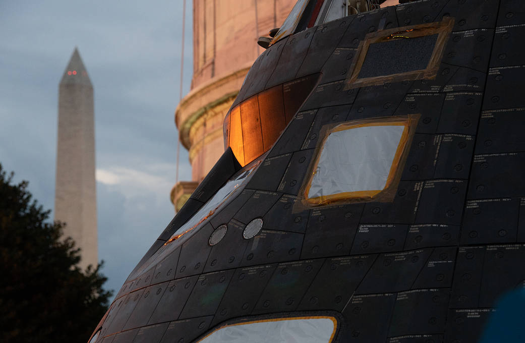 Orion spacecraft in closeup with Washington Monument in left of frame
