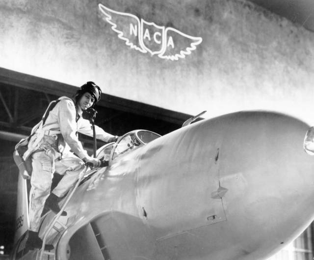 Test pilot Lawrence A. Clousing climbs into his Lockheed P-80.