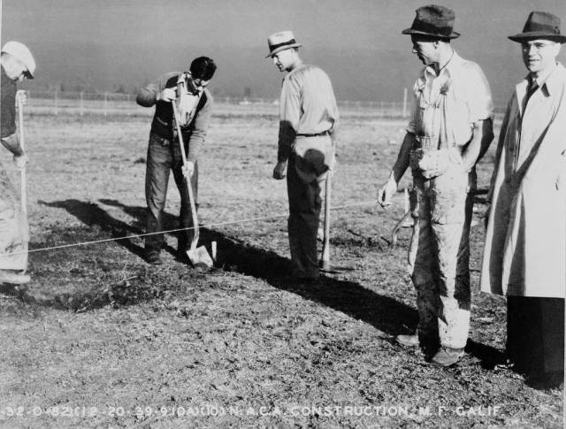Shown is Russell Robinson (right) supervising the first excavation for the Ames laboratory on Dec. 20, 1939.