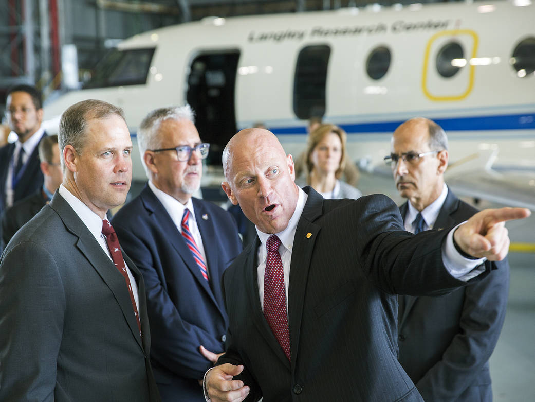 NASA Administrator Bridenstine speaks with Langley officials in aircraft hangar