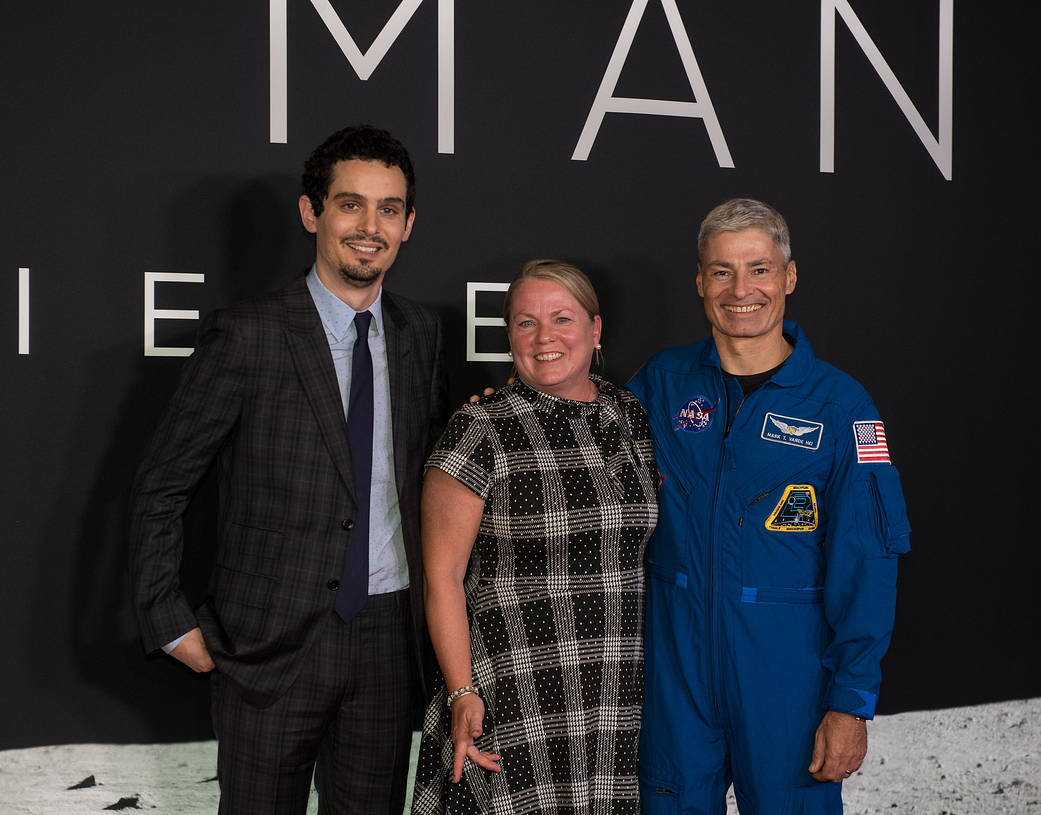 NASA astronaut Mark Vande Hei, right, and his wife Julie, pose for photo with director and producer Damien Chazelle