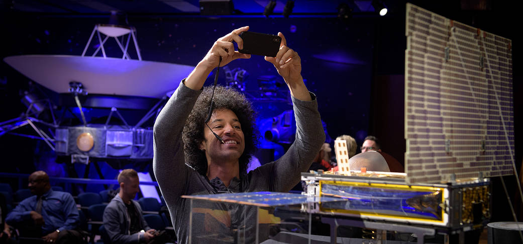 NASA social media participant Bryan Branly takes a photograph of the Mars Cube One