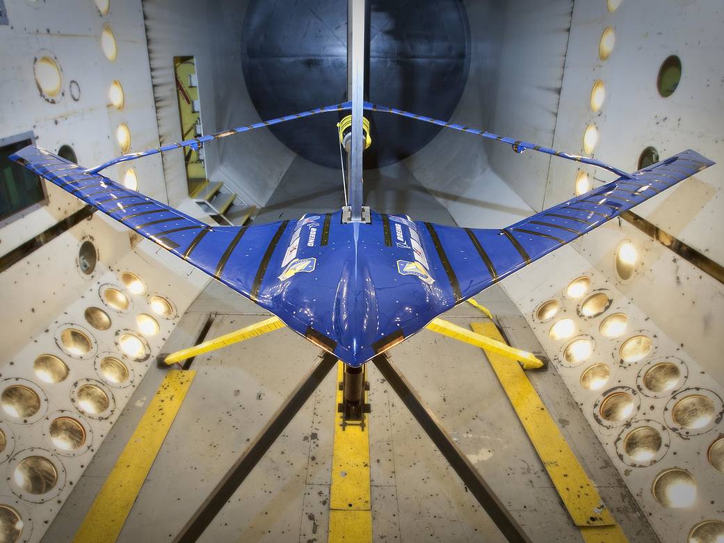 A blue model of a joined wing inside the Transonic Dynamics Tunnel.