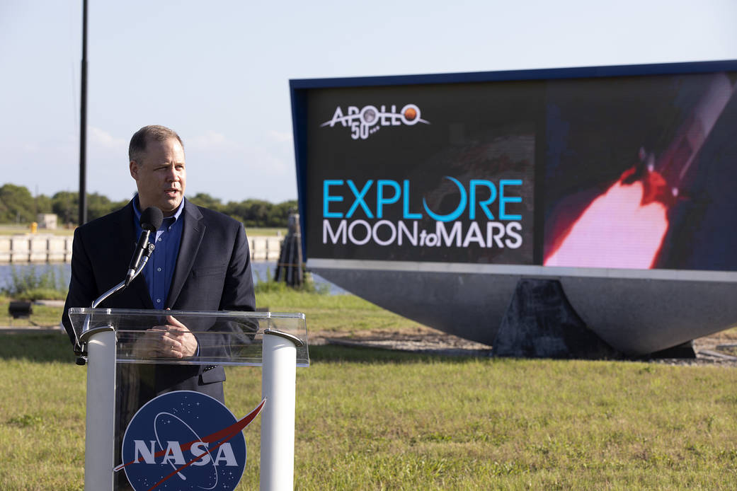 Administrator Bridenstine speaks at podium at Kennedy Space Center outdoors