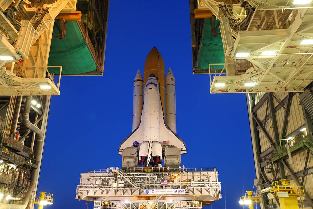 At NASA's Kennedy Space Center in Florida, space shuttle Discovery begins its nighttime trek, known as "rollout," from the Vehicle Assembly Building to Launch Pad 39A.