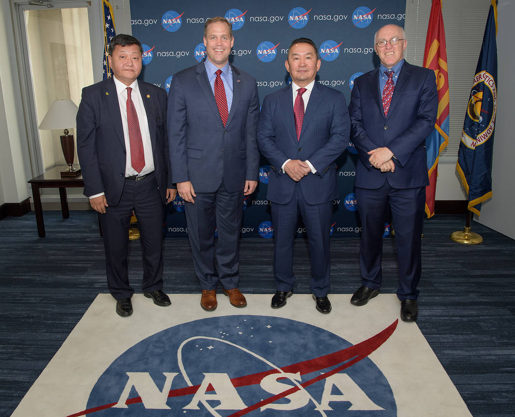 Four officials pose for group photo