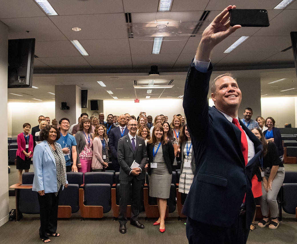 NASA Administrator Jim Bridenstine takes a selfie with the audience at the 2019 Challenger Center Annual Conference