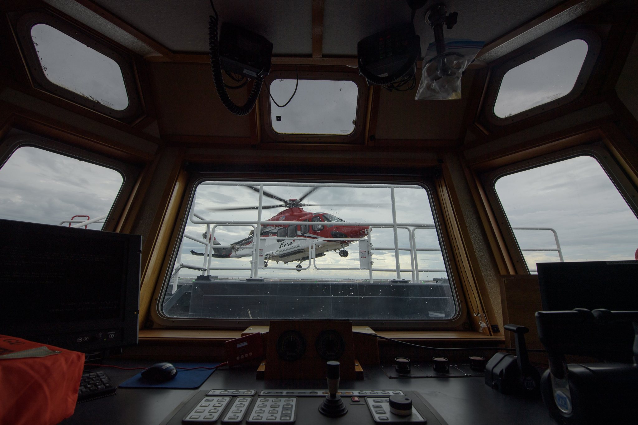 A helicopter equipped for air medical operations lands on the GO Searcher ship