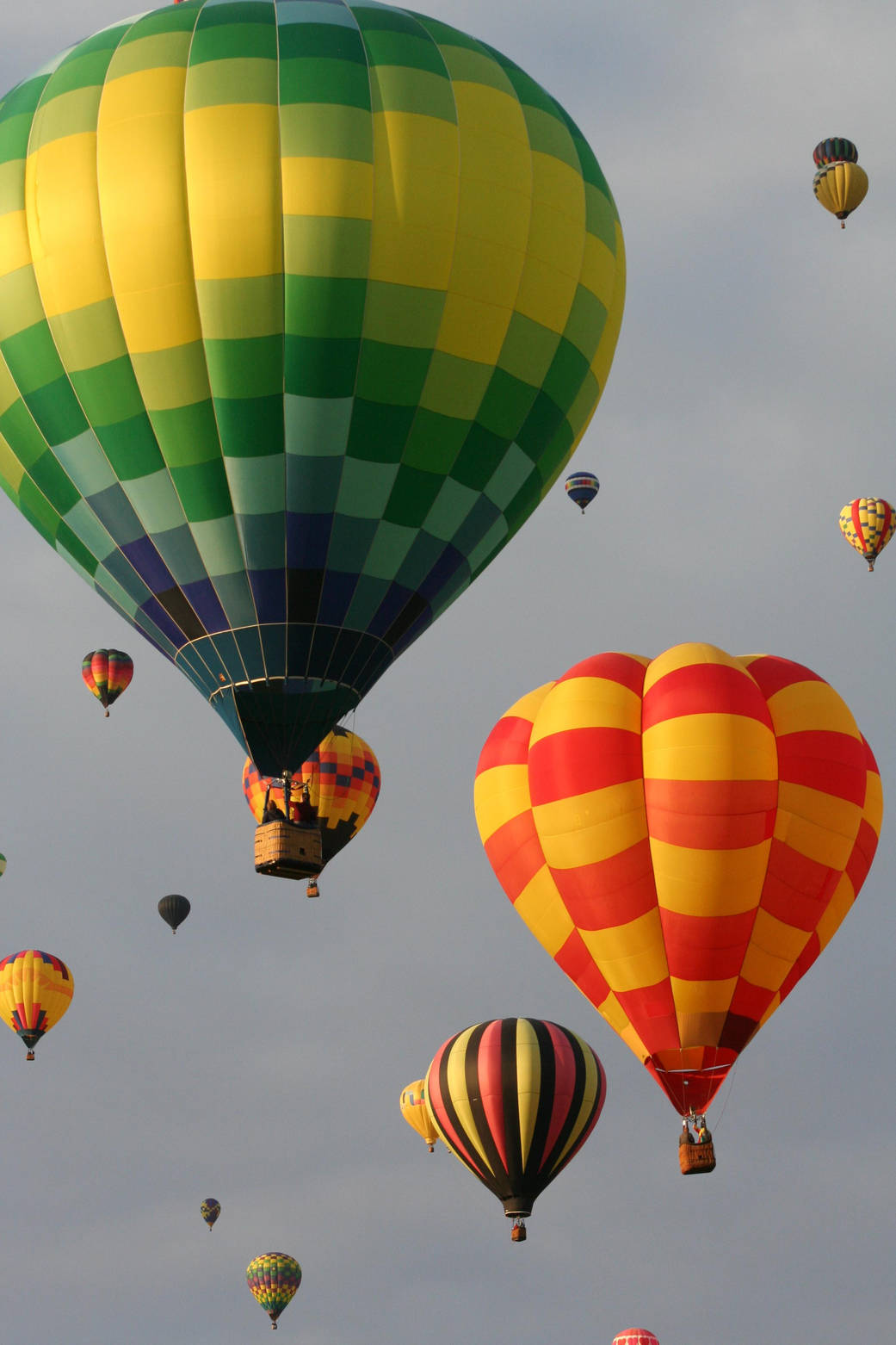 Hot air balloons lift off en masse under sullen skies at the Albuquerque International Balloon Fiesta in Albuquerque, N.M.