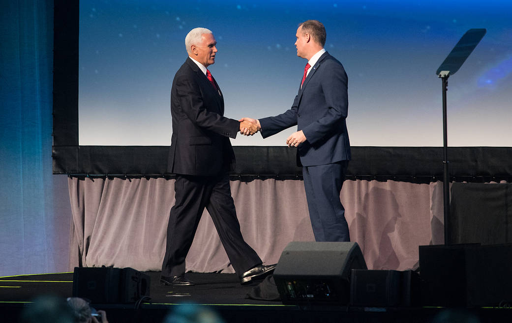 ASA Administrator Jim Bridenstine, right, shakes hands with Vice President Mike Pence after introducing him at the 2019 IAC