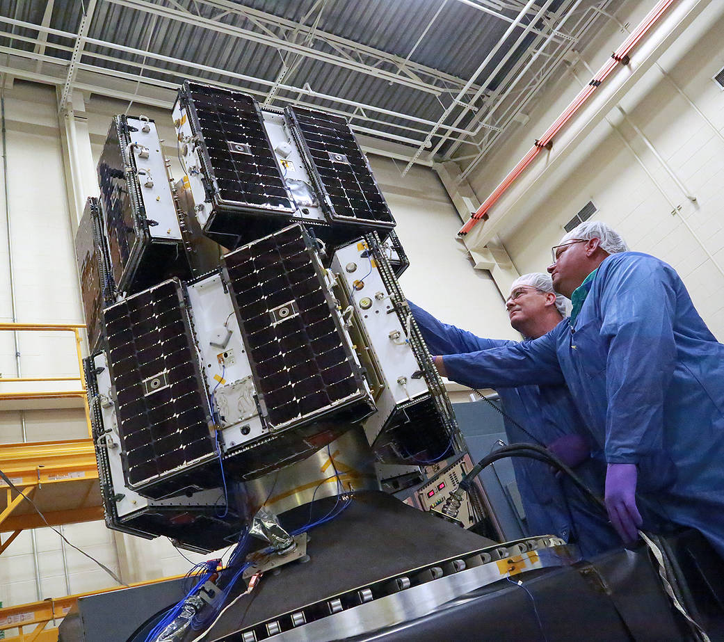 Engineers prepare NASA’s eight CYGNSS microsatellites for vibration testing.