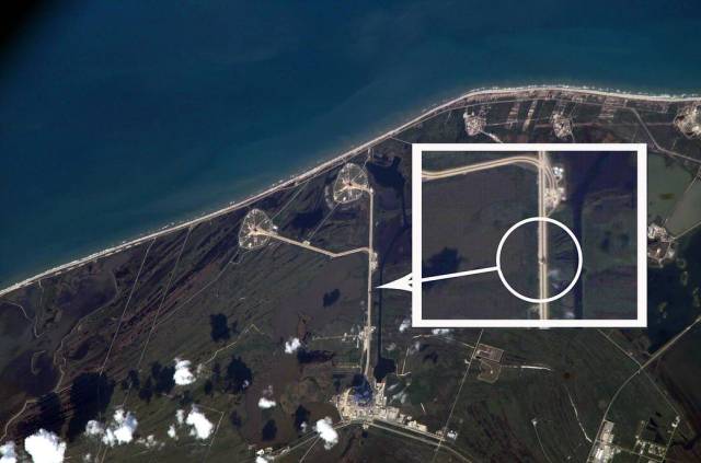 Aboard the International Space Station, Expedition 10 Commander Leroy Chiao used a digital camera to photograph the rollout of the Space Shuttle Discovery at NASA’s Kennedy Space Center from an altitude of 220 statute miles.