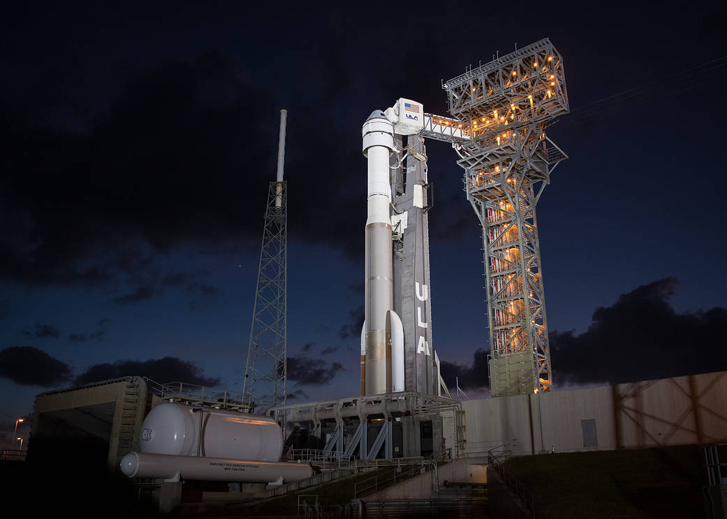 Starliner atop Atlas V rocket at night