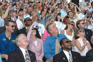 In the stands at Kennedy Space Center, First Lady Laura Bush and other guests follow the path of space shuttle Discovery as it successfully lifts off from Launch Pad 39B on the return to flight mission, STS-114.