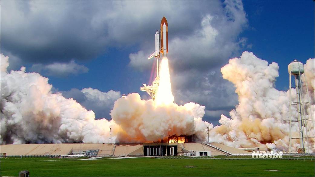 As billows of smoke and steam roll away, space shuttle Discovery leaps from Launch Pad 39B on the historic return to flight mission STS-114.