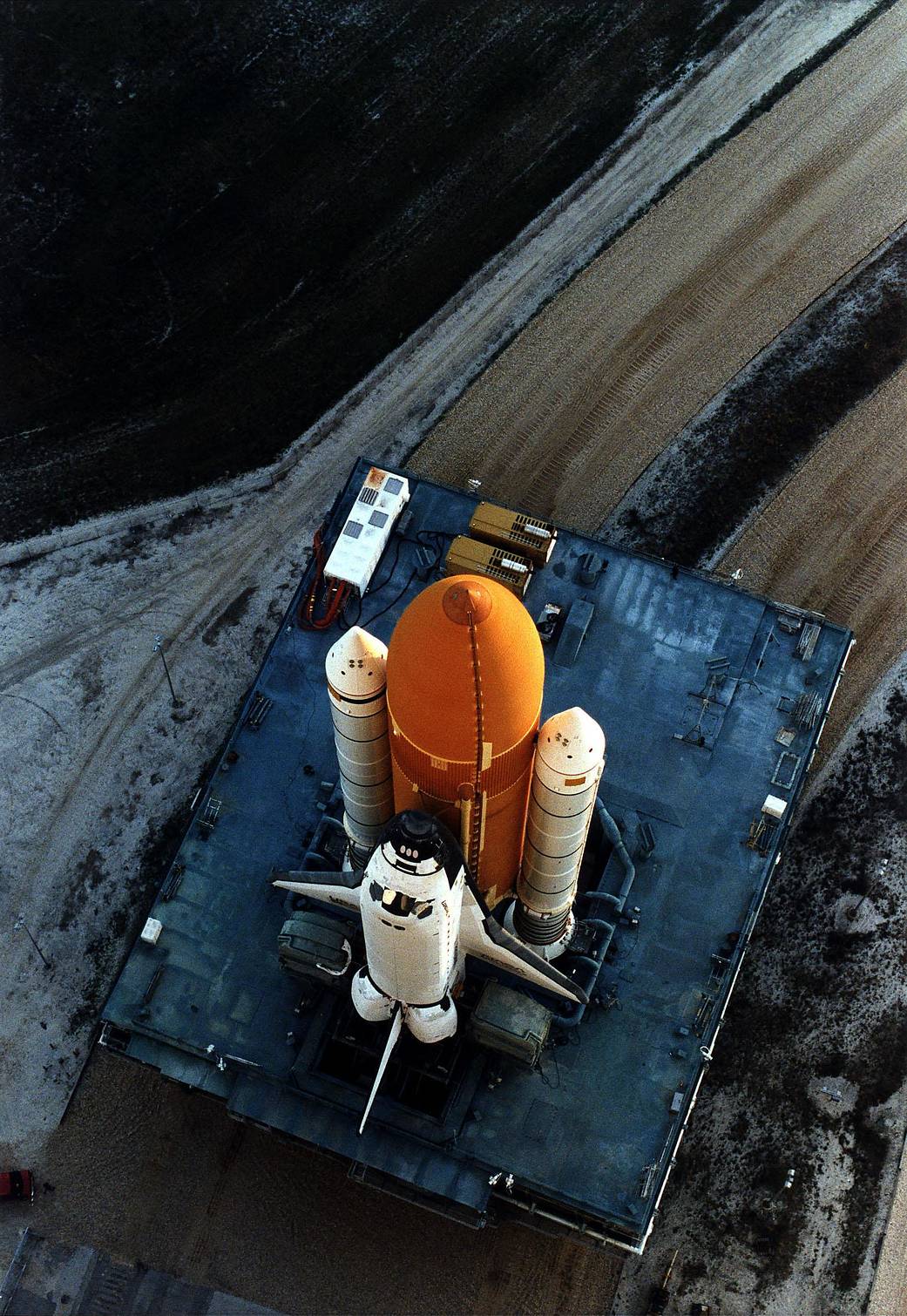 Carried by its mobile launcher platform, shuttle Discovery slowly moves through the high bay doors of the Vehicle Assembly Building on the way to Launch Pad 39A before the STS-82 mission.