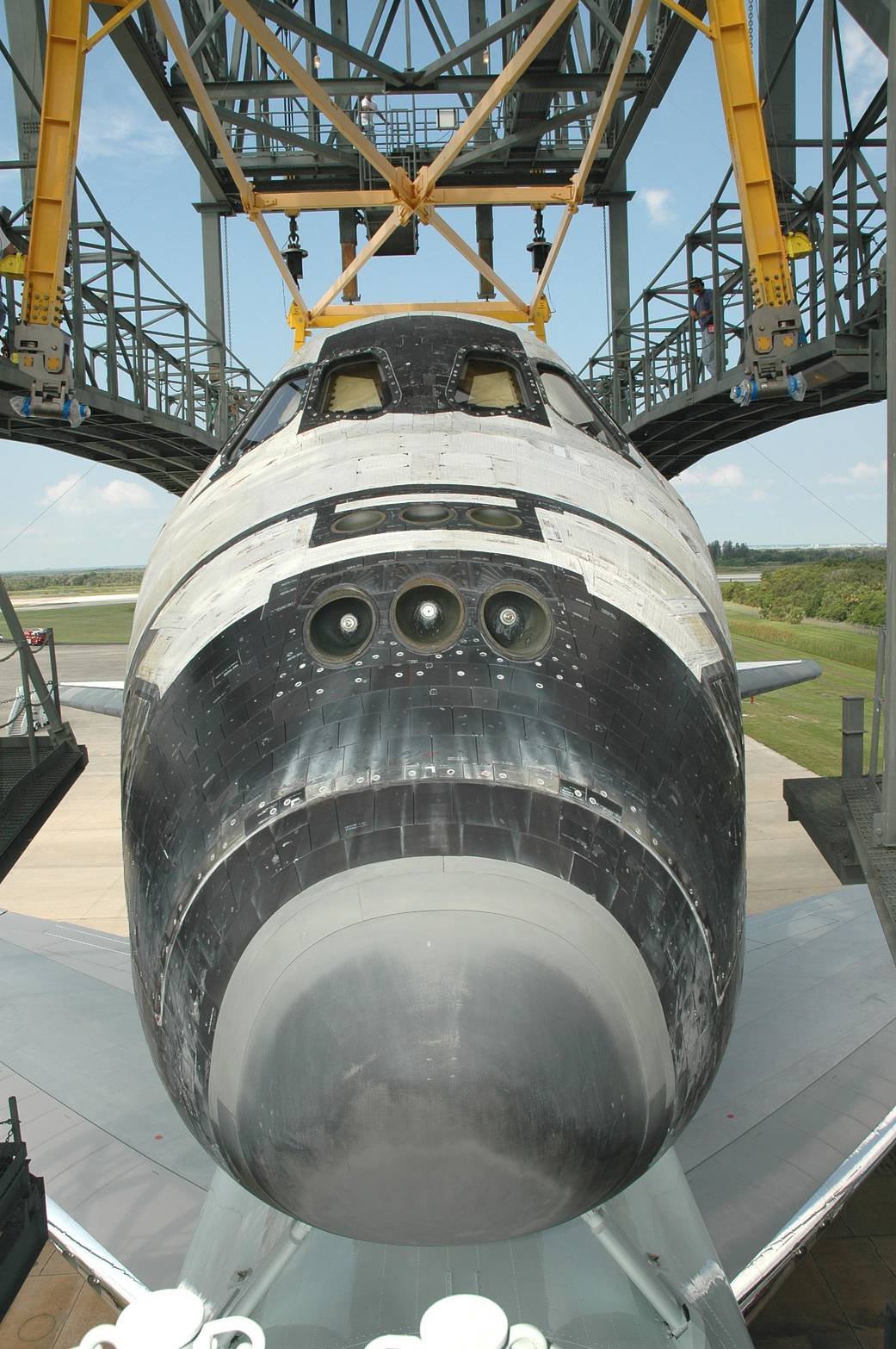 Discovery sits on top of the Shuttle Carrier Aircraft, a modified Boeing 747, as it is towed into the mate/demate device at NASA Kennedy Space Center’s Shuttle Landing Facility.