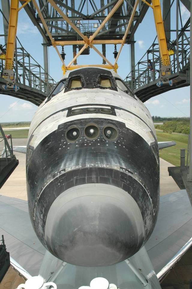 Discovery sits on top of the Shuttle Carrier Aircraft, a modified Boeing 747, as it is towed into the mate/demate device at NASA Kennedy Space Center’s Shuttle Landing Facility.