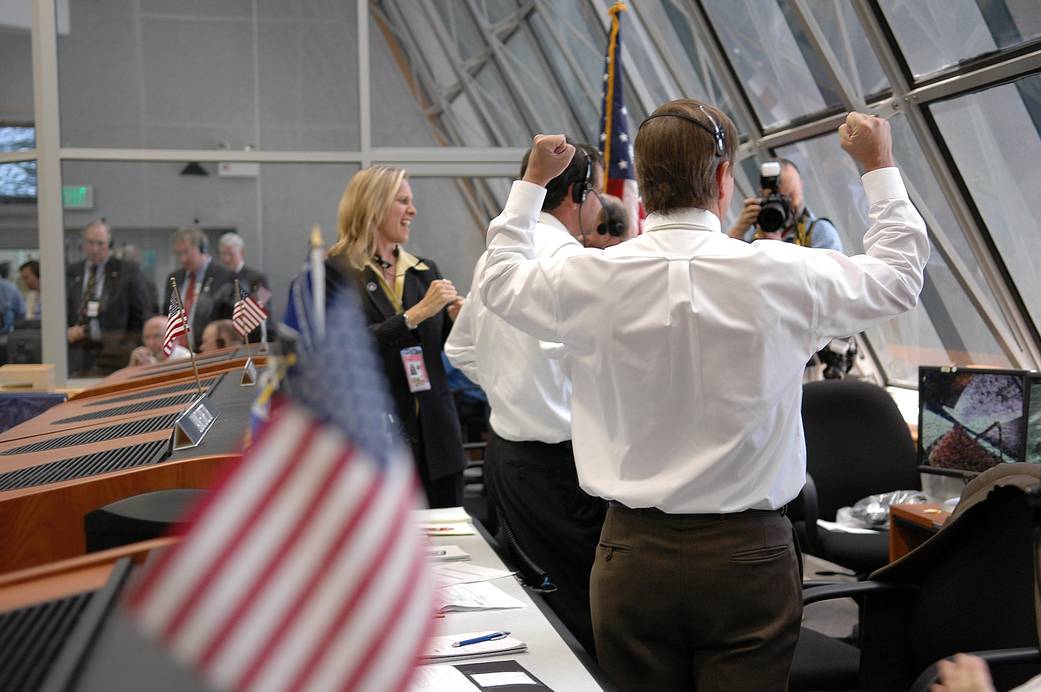 In Firing Room 4 of the Launch Control Center, Shuttle Launch Director Mike Leinbach (foreground) cheers over the successful liftoff of space shuttle Discovery on mission STS-121.