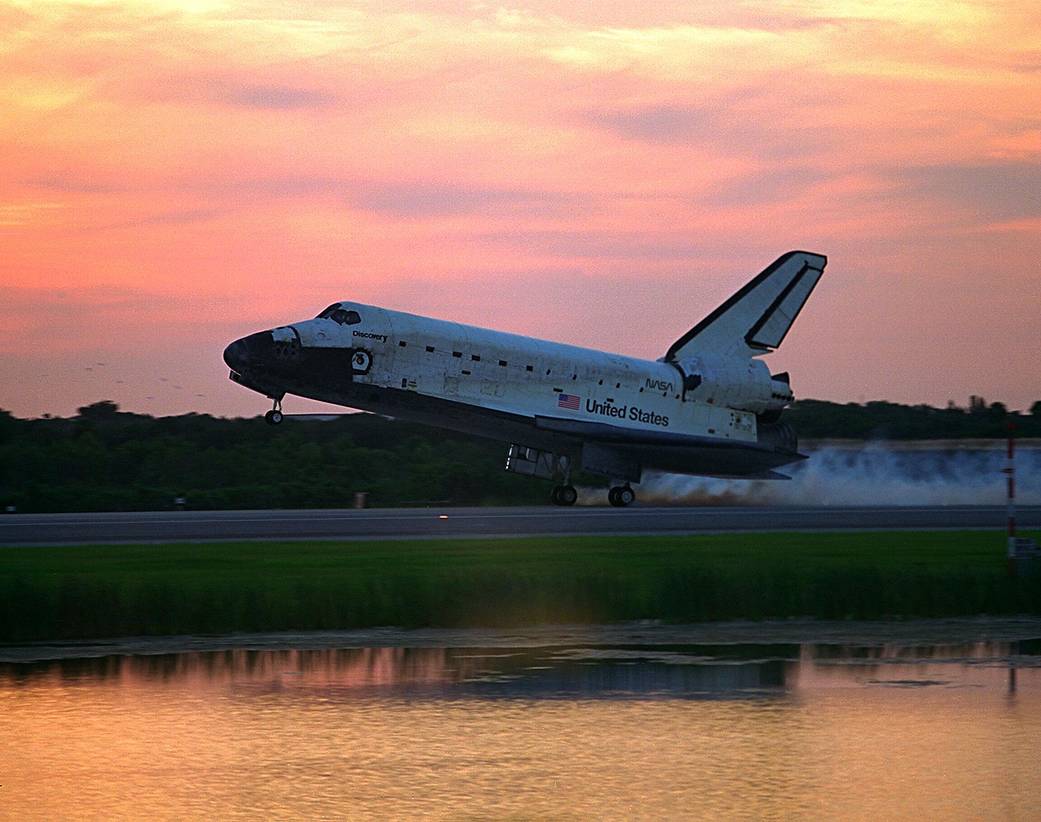 Sunrise paints a stunning backdrop for space shuttle Discovery as it touches down on Runway 33 at Kennedy's Shuttle Landing Facility at 7:07:59 a.m. on Aug. 19, 1997.