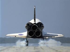 Seen from behind, space shuttle Discovery kicks up dust as it touches down on Runway 33 of the Shuttle Landing Facility at NASA's Kennedy Space Center to complete the 15-day mission STS-120.