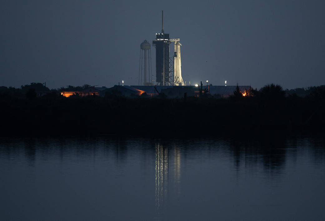 Crew Dragon spacecraft onboard is seen illuminated on the launch pad at Launch Complex 39A