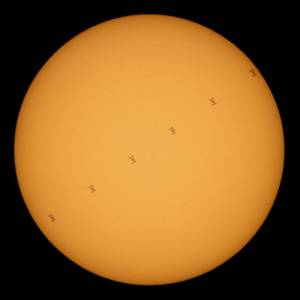 International Space Station in silhouette as it transits the Sun at roughly five miles per second