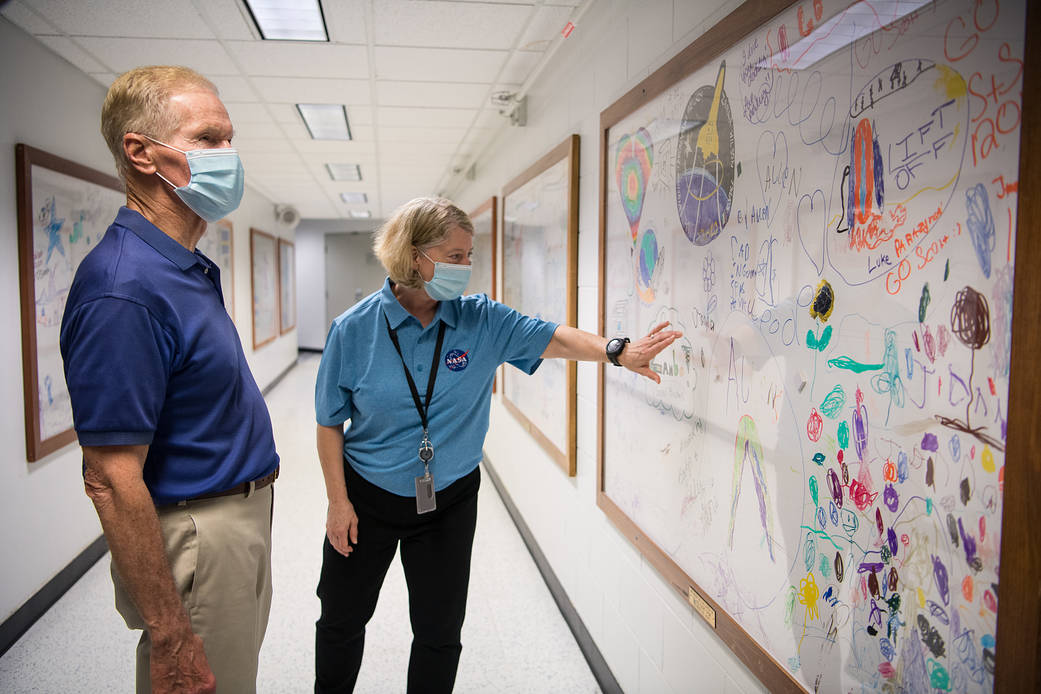 NASA Deputy Administrator Pam Melroy, right, shows NASA Administrator Bill Nelson the white board created by the families of the astronauts of the STS-120 mission, NASA’s Kennedy Space Center in Florida.