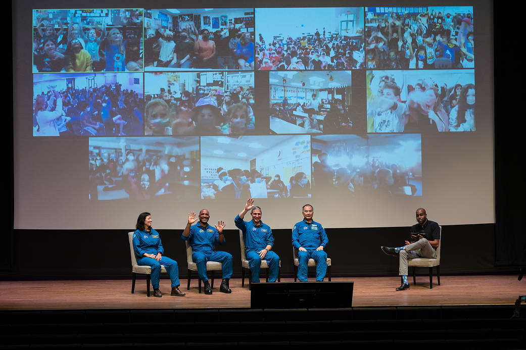 SpaceX Crew-1 NASA astronauts wave at students during a live question and answer session  at the National Museum of African American History and Culture, Tuesday, Nov. 16, 2021, in Washington. 