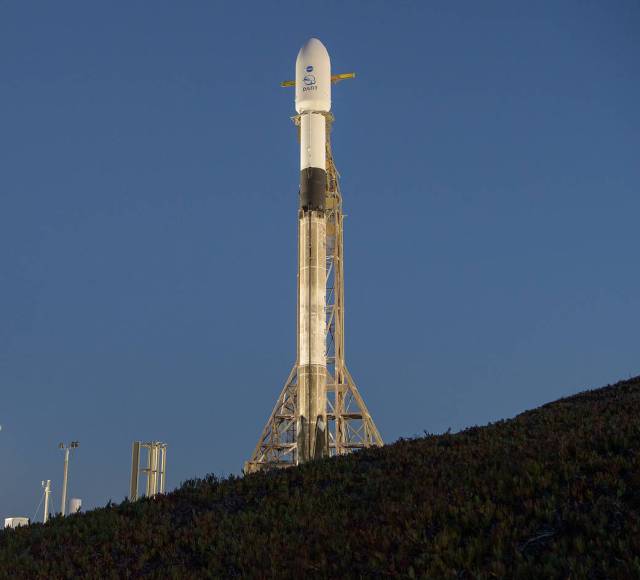 The SpaceX Falcon 9 rocket with the Double Asteroid Redirection Test, or DART, spacecraft onboard, is seen during sunrise, Tuesday, Nov. 23, 2021, at Space Launch Complex 4E, Vandenberg Space Force Base in California.