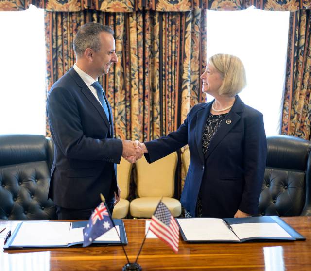 Australian Space Agency Head Enrico Palermo, left, and NASA Deputy Administrator Pam Melroy, shake hands after signing a joint statement of intent for cooperation in Earth science.