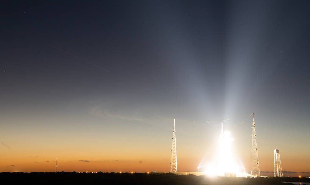 In this 30-second exposure the International Space Station is seen as it passes over NASA’s Space Launch System (SLS) rocket with the Orion spacecraft aboard at NASA’s Kennedy Space Center in Florida.