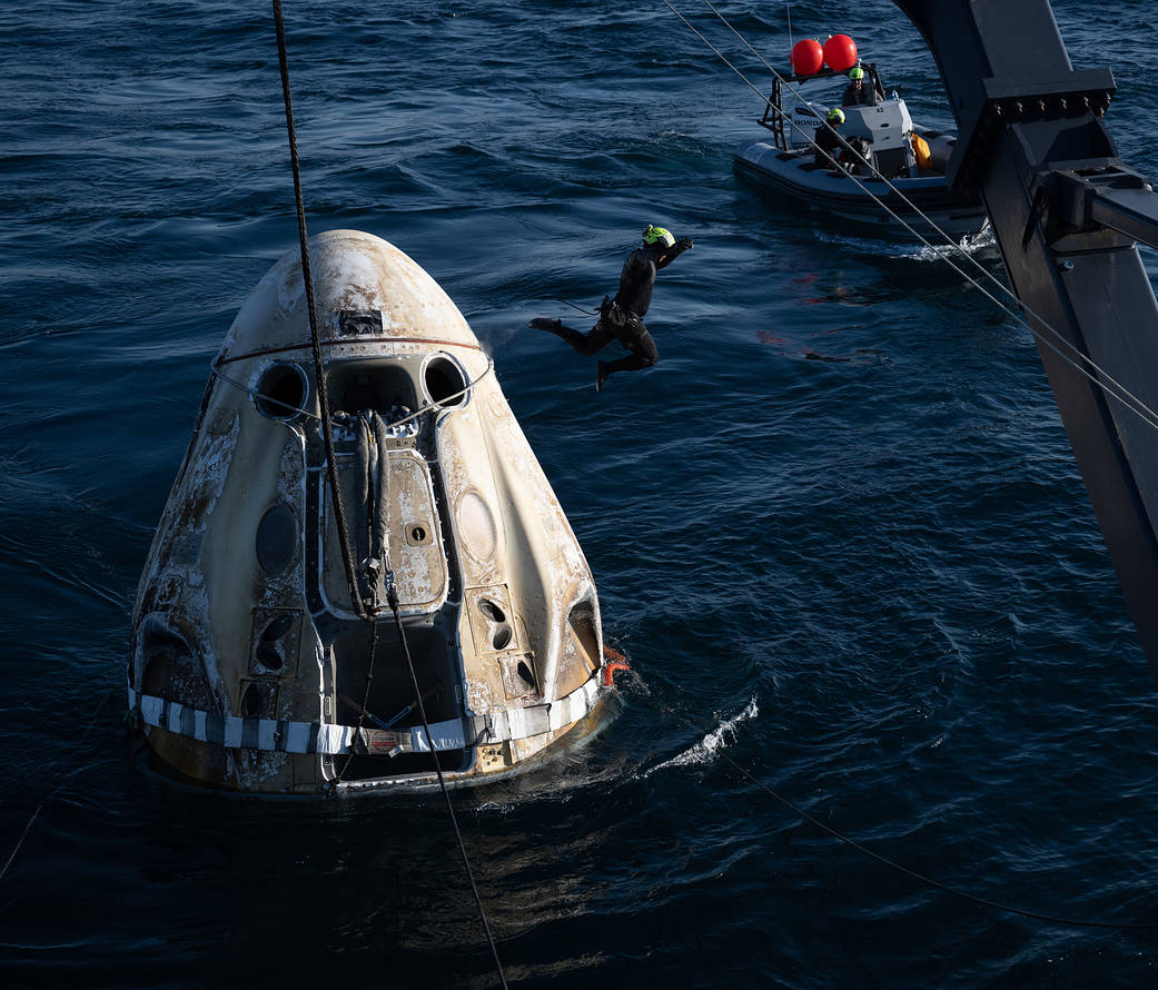Support teams work around the SpaceX Crew Dragon Freedom spacecraft shortly after it landed with NASA astronauts Lindgren, Hines, Watkins, and ESA astronaut Cristoforetti aboard in the Atlantic Ocean off the coast of Jacksonville, Florida, Oct. 14, 2022.