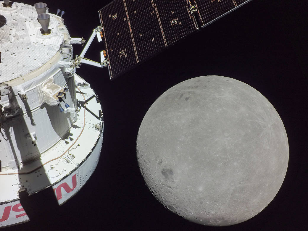 A portion of the far side of the Moon looms large just beyond the Orion spacecraft in this image taken on the sixth day of the Artemis I mission by a camera on the tip of one of Orion's solar arrays.