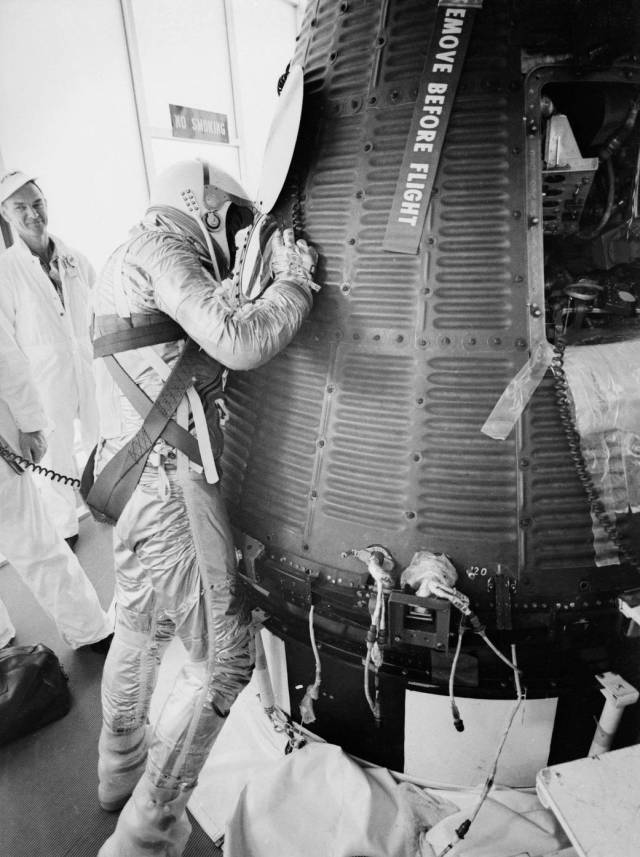 Alan Shepard looking inside Freedom 7 capsule