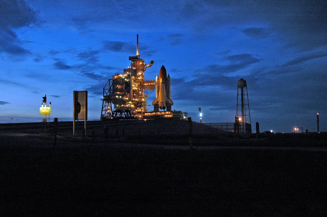 Space shuttle Atlantis glows in the dusk as it awaits its upcoming liftoff from Launch Pad 39B at NASA's Kennedy Space Center in Florida.